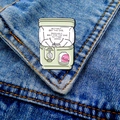 Creative Gashapon machine enamel pin on denim jacket with colorful capsule toy details - Gashapon Machine