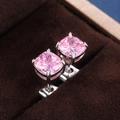 Macro shot of pink square-cut zircon earrings with silver-tone four-prong setting - Pink