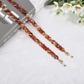 Detail of amber acrylic glasses chain with gold lobster clasp and silicone loop - Light Amber (D4422)