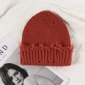 Distressed rust red ribbed beanie with vintage frayed hole details for a street style look - Red