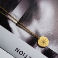 Gold stainless steel necklace with sunburst star pendant on a lifestyle magazine - Eight-pointed Star/Zircon / Gold