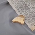 Detailed close-up of a golden heart-shaped metal hair claw clip with textured surface - Brushed Gold Half Heart
