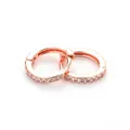 Close-up of rose gold huggie hoop earrings with micro-paved white cubic zirconia stones - Rose Gold - White Zircon