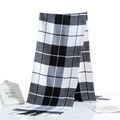 Detailed view of black and white checkered scarf with soft fringe texture and drape - Black White Cross Check