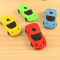 Racing car shaped erasers in red, yellow, green, and blue on a wooden surface - Racing Car Shaped Eraser