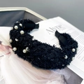 Detail of black faux fur headband with embedded pearls on a soft aesthetic background - Black