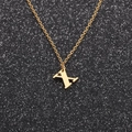 Close-up of gold stainless steel necklace featuring a letter X pendant on black background - Gold X