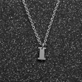 Macro detail of silver stainless steel letter I pendant on a classic cable chain necklace - Steel I