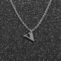 Macro shot of polished silver stainless steel V-letter pendant on a simple O-chain necklace - Steel V