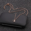Detail of rose gold stainless steel necklace featuring a minimalist U letter pendant - Rose Gold U