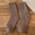 Thick warm brown thermal crew socks in wool blend on rustic wood background - One Size / Light Coffee