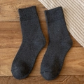 Deep gray thickened thermal wool socks for women displayed on a rustic wooden background - One Size / Dark Gray