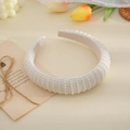 Elegant wide bridal headband adorned with rows of white pearls on beige background - Style B