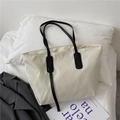 Minimalist beige tote bag with black straps on bedding for a casual commute look - Without Pendant / Beige