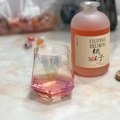 Iridescent hexagon glass cup with diamond cut surface holding a pink beverage - Rainbow Short Hexagon Glass Cup