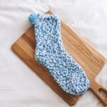 Blue and white coral fleece mid-calf socks with cute pom-pom detail on wooden tray - One Size / Light Blue