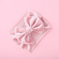 Macro view of velvet bow and ribbed elastic fabric on a pink baby headband - Pink