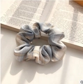 Blue and yellow plaid organza scrunchie on an open book for a stylish hair accessory - Lemon Sea Salt Blue Grid