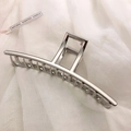 Macro view of silver geometric metal hair claw clip with polished finish and large comb teeth - Silver-Straight