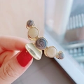 Detailed close-up of golden hair claw clip featuring elegant marble resin beads - Blue-Grey Marble