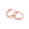 Close-up of polished rose gold hoop earrings featuring a minimal huggie buckle design - Rose Gold - Smooth