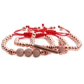 Macro detail of rose gold crown beads and zircon spheres on red woven adjustable bracelets - Rose Gold Crown Collection