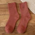 Thick reddish brown wool blend thermal crew socks on a rustic wooden background - One Size / Orange Red