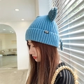 Blue knit beanie featuring cute cat ears and pom-poms for a stylish winter look - M (56-58cm) / Aqua