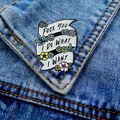Enamel ribbon brooch with floral design on denim jacket featuring bold punk slogan - Flower Ribbon