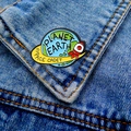 Cartoon Planet Earth Space Cadet enamel pin on a blue denim jacket pocket - Earth Rocket