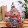 Christmas teddy bear plush toy wearing festive knitted hat on a snowflake gift box base - Bear