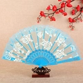 Light blue lace folding fan with gold embroidery and floral patterns on a wooden stand - Fan / Sky Blue