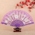 Elegant purple lace folding fan with white rose floral patterns on a dark wooden stand - Fan / Purple