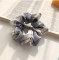 Gray and white plaid scrunchie hair tie on an open book, soft minimalist aesthetic - Gentle Blue White Check