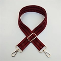 Close-up of adjustable red and black ethnic pattern bag strap with gold metal hardware - Burgundy