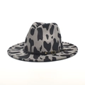 Detail of gray cow print wool fedora featuring a brown leather band with gold metal buckles - M (56-58cm) / Gray
