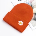 Knitted beanie hat in bright orange with white daisy embroidery and ribbed texture - Orange Red