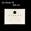 Detailed view of white earring display cards in 8x6cm size on a dark background - Earring Card #5 (Approx. 100Pcs)
