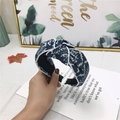 Handheld blue denim knotted headband with white geometric patterns and contrast piping - Geometric Pattern