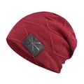 Close-up of wine red winter knit hat featuring a black leather logo patch and star star detail - Burgundy