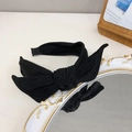 Classic black velvet bow headband with wide bunny ears design in a minimalist retro style - Black