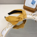 Ginger yellow suede headband with bow knot style on vintage white mirror stand - Yellow
