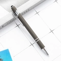 Deep grey matte 2-in-1 stylus ballpoint pen with silver metal clip on white grid paper - Gray