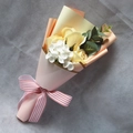 Detailed top view of a mini bouquet with yellow soap roses and pink paper wrap - Champagne