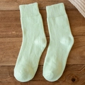 Thick light green thermal crew socks for women with rib knit cuffs on dark wood background - One Size / Light Green
