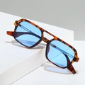 Retro tortoise pilot sunglasses with light blue lenses and double bridge on white pedestal - Leopard Frame Blue Lens