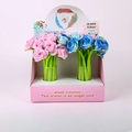 Close-up of 0.5mm rose-shaped silicone pens in pink and blue display box - 6605-2 Rose-Black Ink