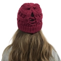 Detail of burgundy knit beanie featuring a cross-pattern hole for high ponytails - Burgundy