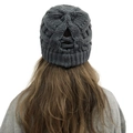 Detail showing cross-back messy bun hole on a dark grey cable knit winter beanie - Dark Gray