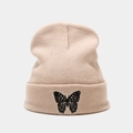 Detailed close-up of butterfly embroidery on a warm beige ribbed knit beanie hat - M (56-58cm) / Beige